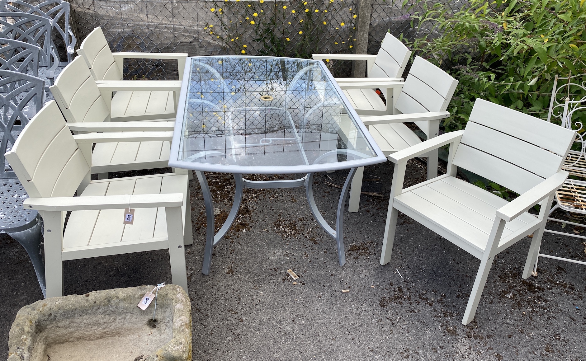 A Laura Ashley rectangular glass topped metal garden table, length 166cm, depth 96cm, height 70cm and a set of six Laura Ashley painted teak elbow chairs